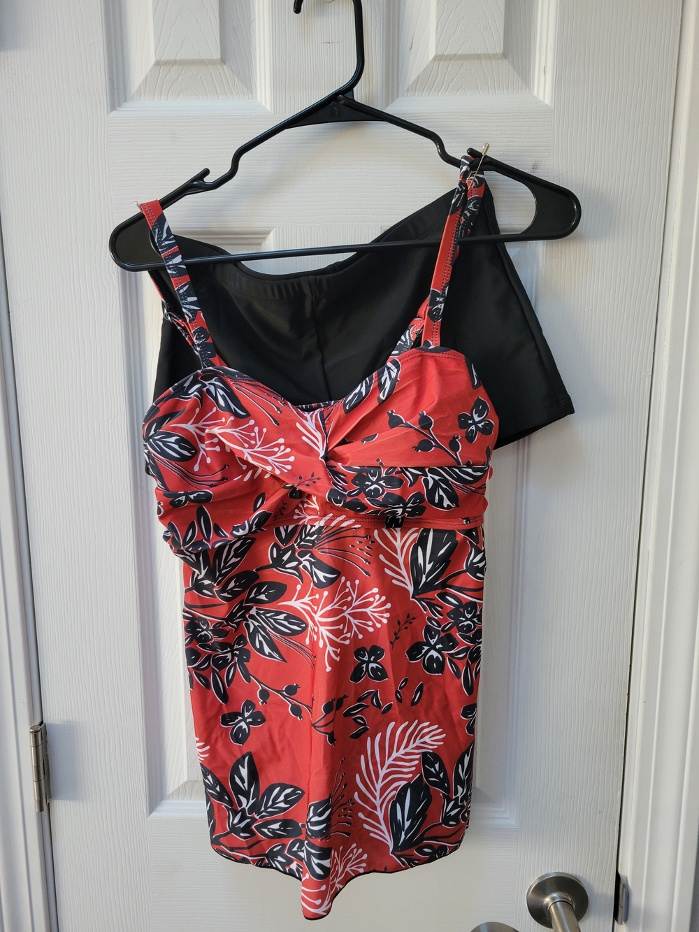 Burnt orange floral tankini with black swim shorts